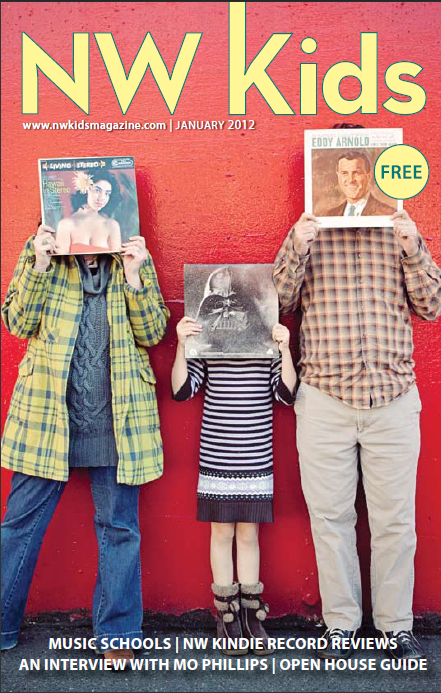 man, woman and girl with record albums covering faces