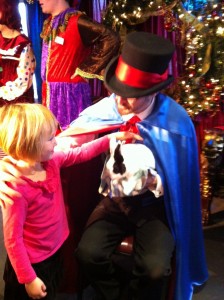 Little girl petting magician's bunny