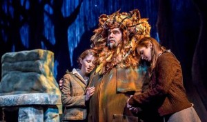 Man dressed as lion with two kids