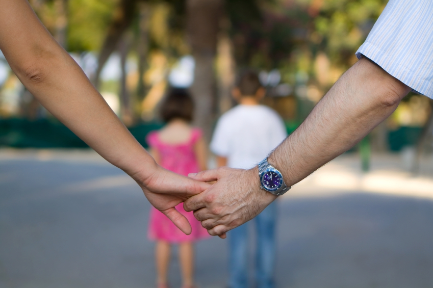 Parents Holding Hands with Kids in Front