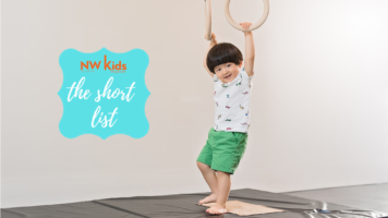 toddler hanging from gymnastics rings