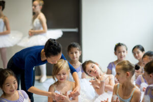 Artistic Director Xuan Cheng directs a student.